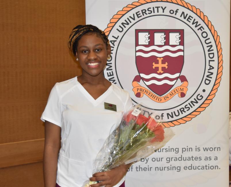 A student holding flower at crest ceremony for new students